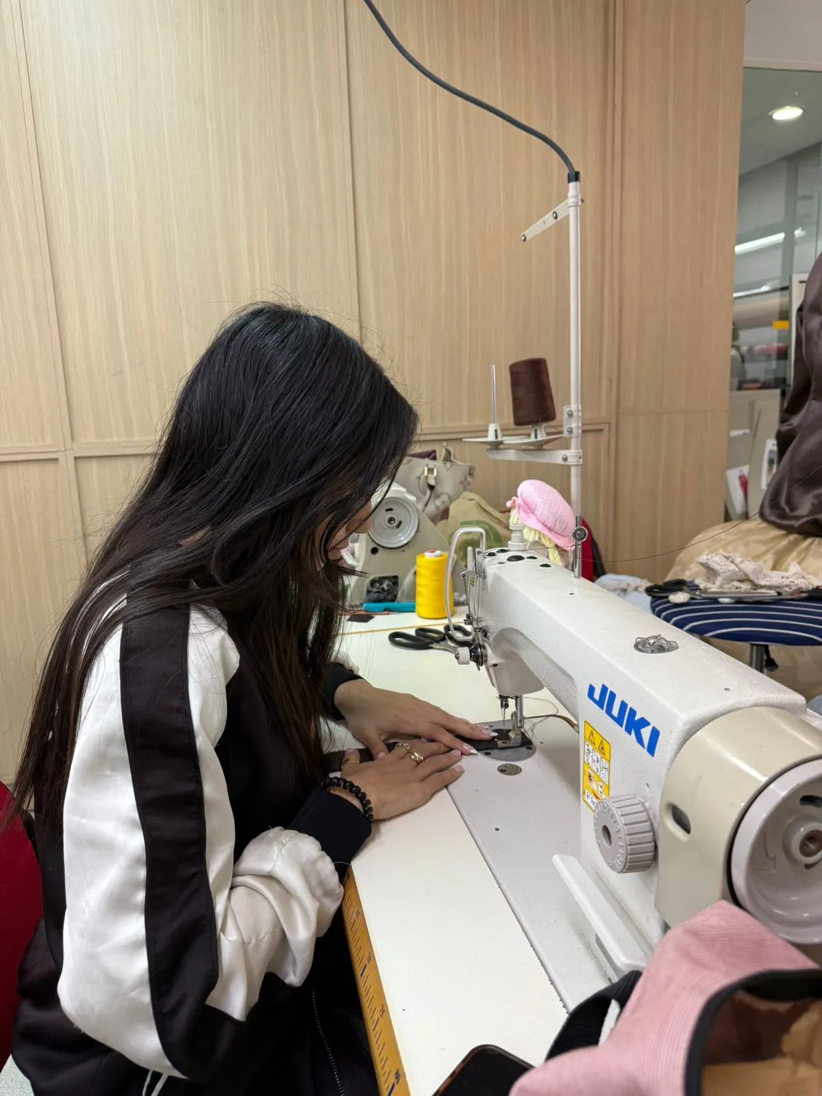Aya Zerouali working at her sewing machine while developing pieces for “Perfectly Broken” / Courtesy of Aya Zerouali 